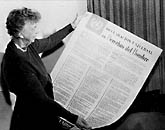 [photo: ER holding a copy of the Universal Declaration of Human Rights in Spanish, 1949]