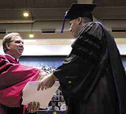 Dean Young congratulates a graduate.