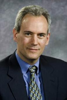 Headshot of Steven Vogel dressed in professional clothing with grey background
